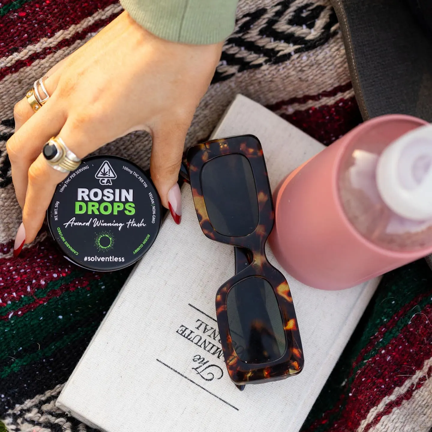 Rosin Tech Labs jar of Rosin Drops concentrate next to sunglasses and drink